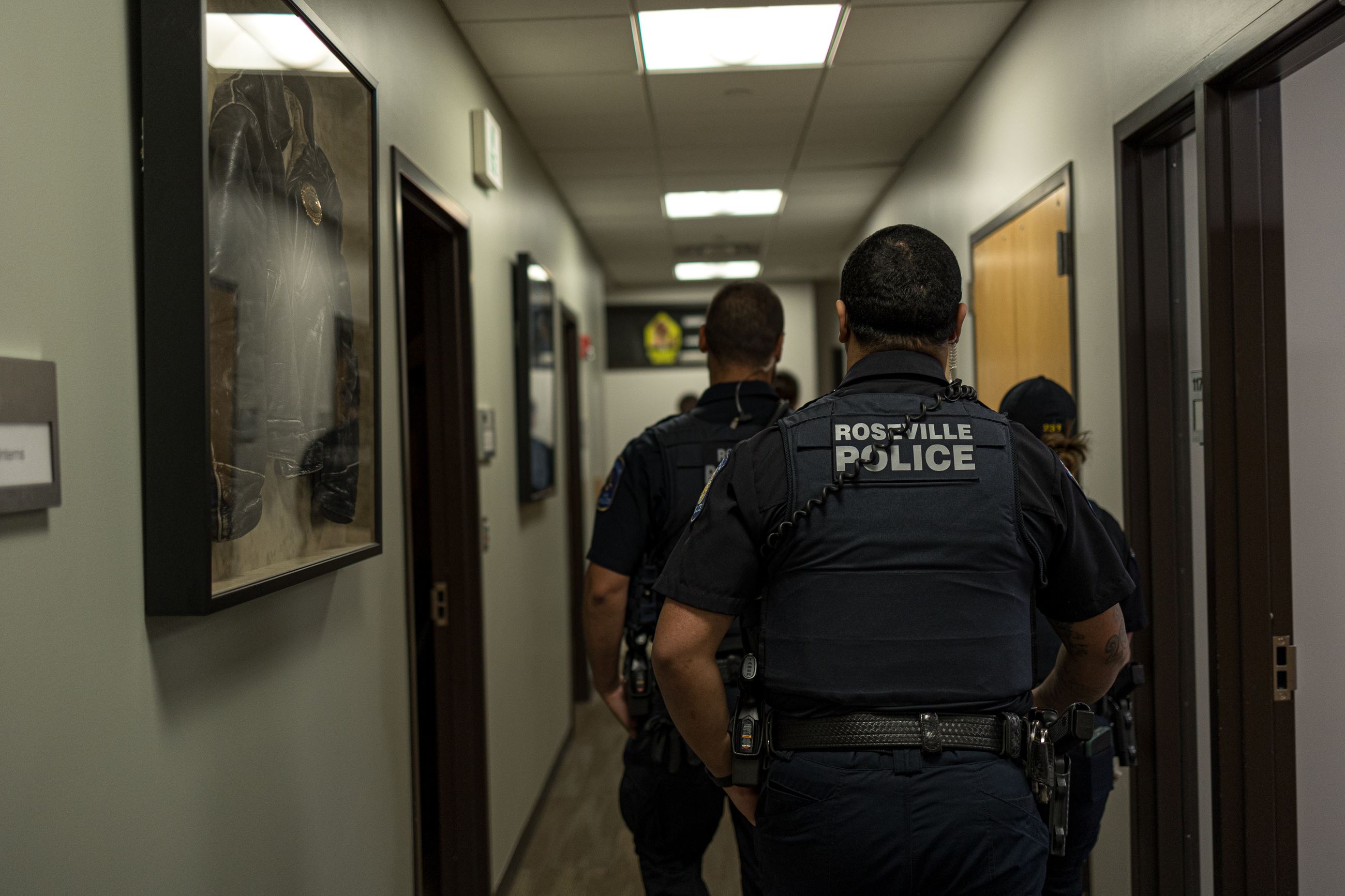 3 officers walking down hallway