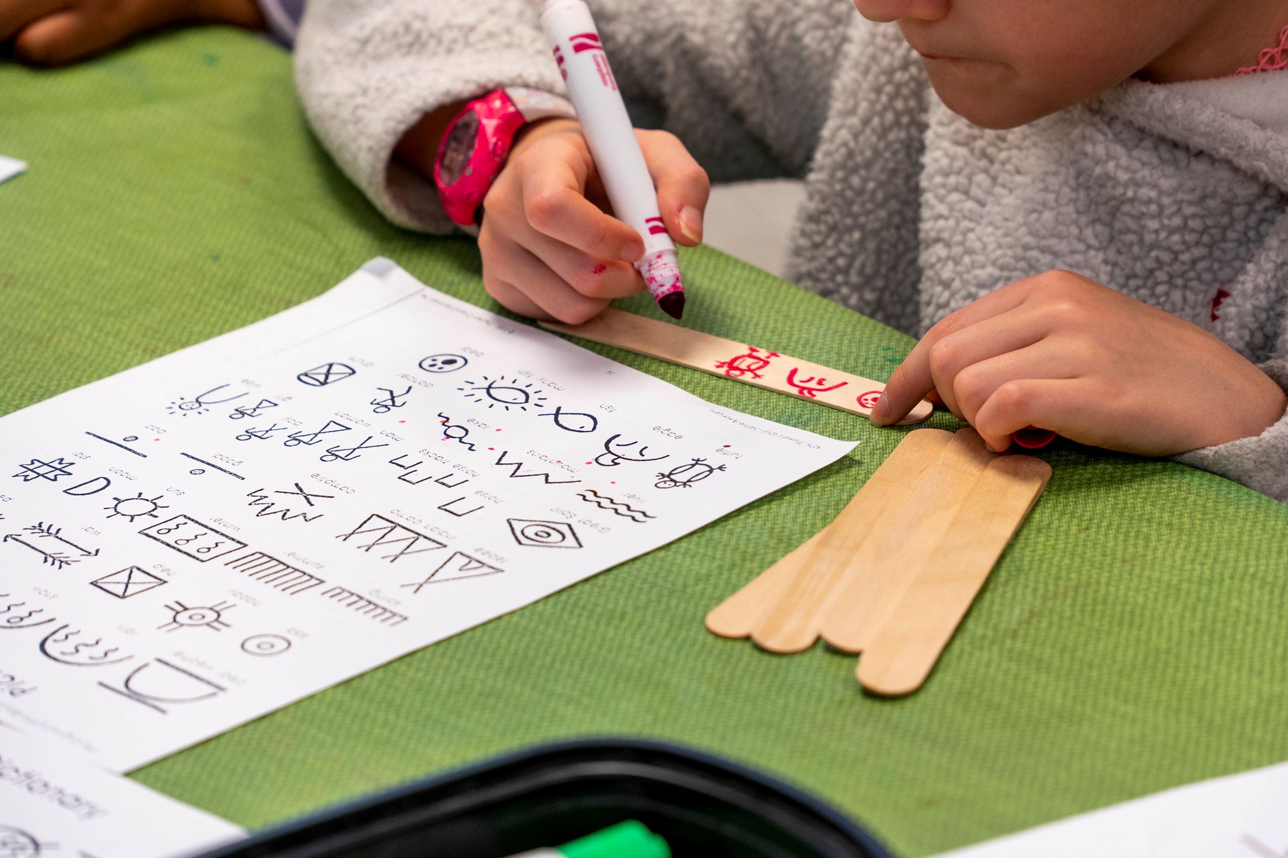 A student does Native American-inspired crafts.