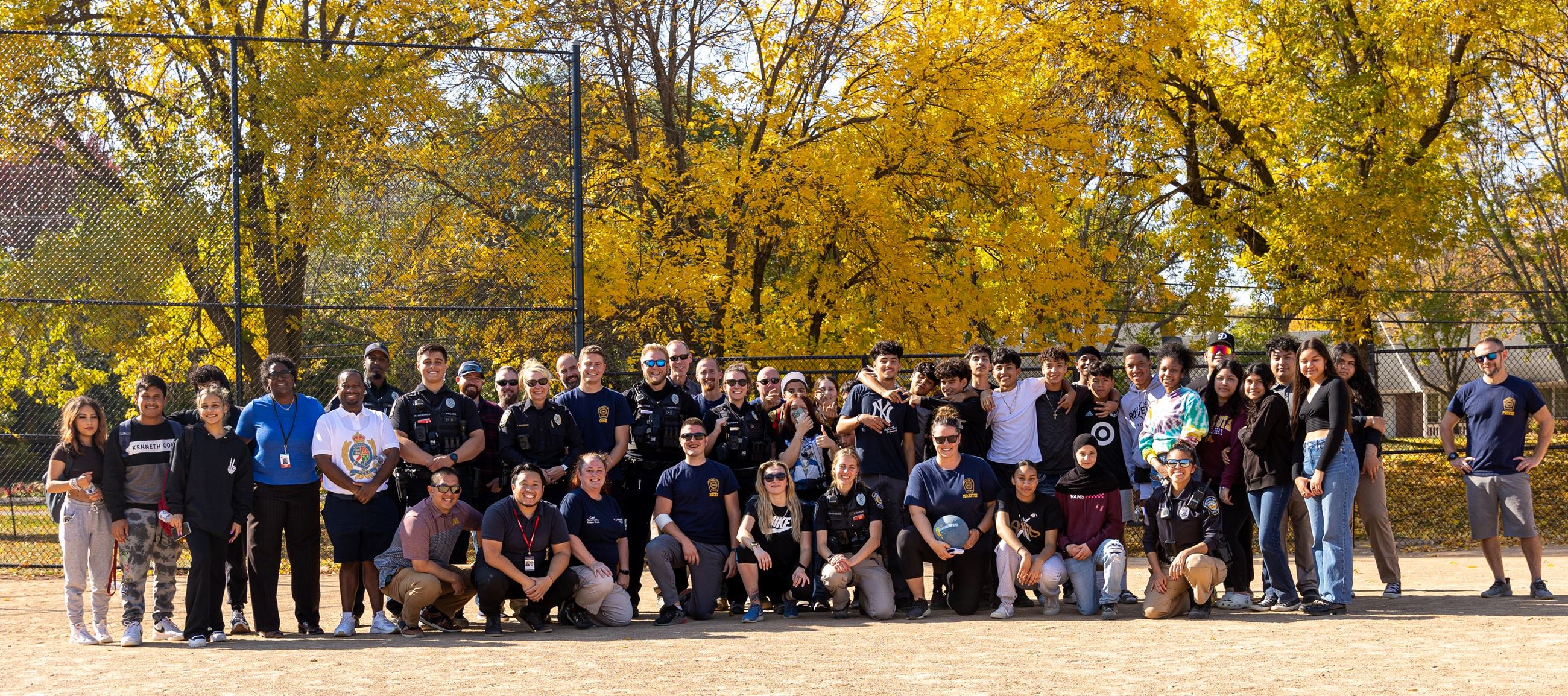A group picture from the "Kick it with Cops" kickball event with Roseville Area High School.