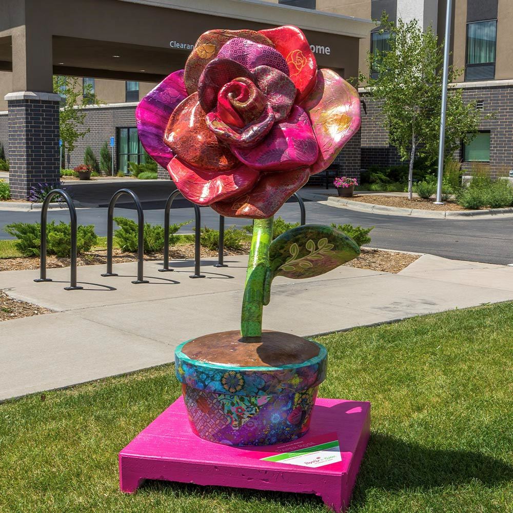 A Roseville in Bloom statue: Paper Rose by Kristi Abbott