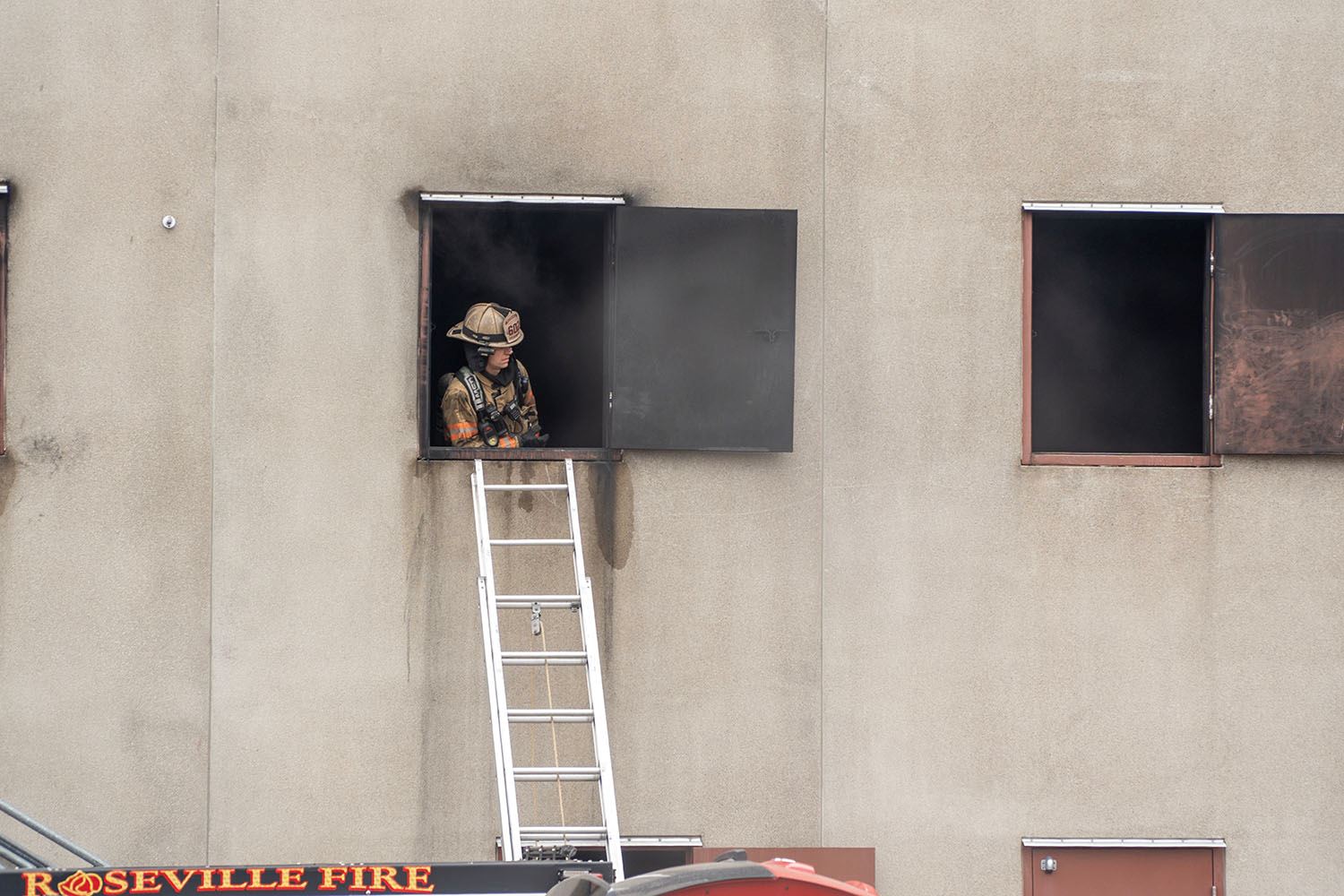 Assistant Fire Chief Neil Sjostrom looks out of a window during a live burn training.