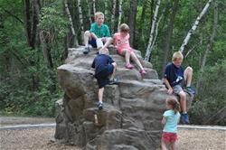 Children playing on a rock at Materion Park