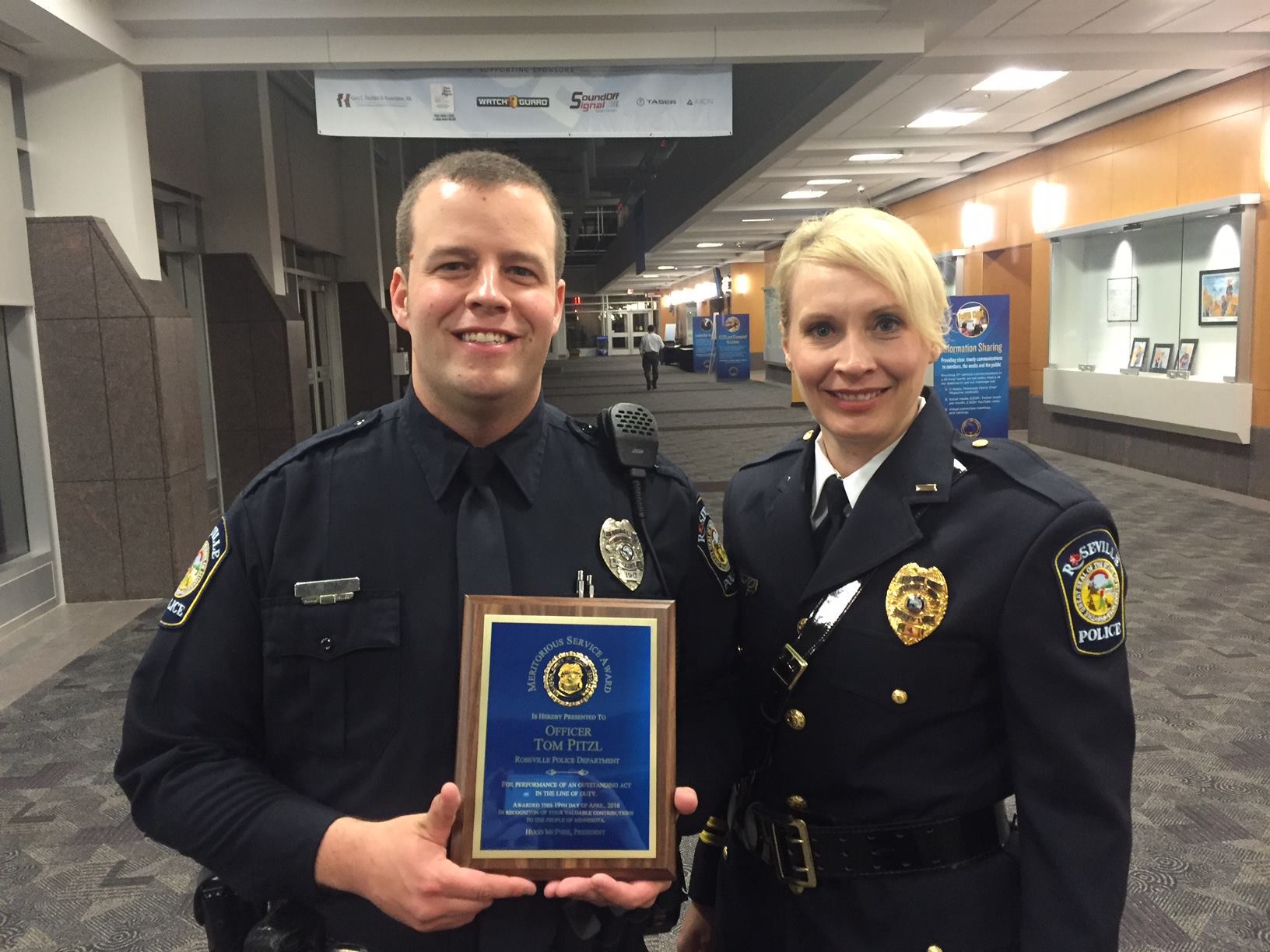 Tom Pitzl accepts an award with Chief Erika Scheider.