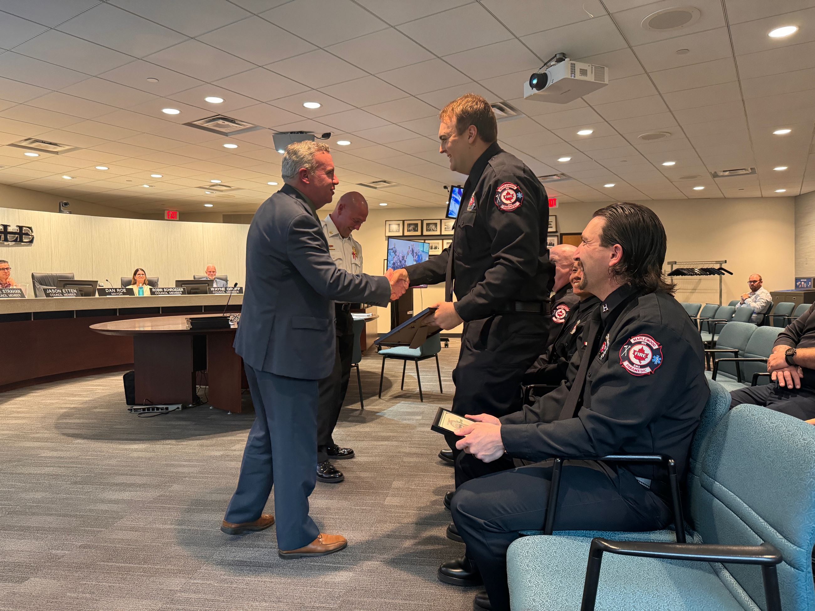 Mayor Dan Roe presents awards to Roseville and Maplewood Firefighters.