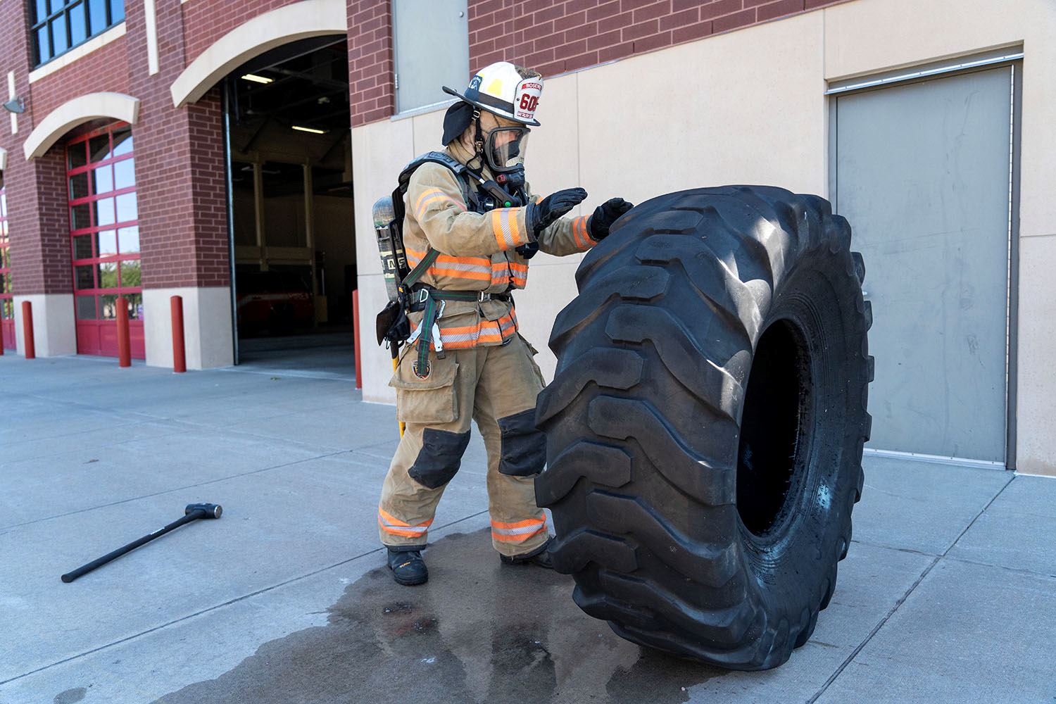 A firefighter works on functional fitness activities.