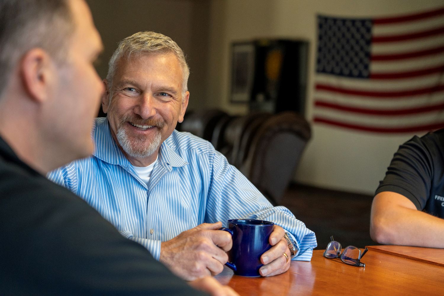 Therapist Jonathan Bundt talks with firefighters at the Roseville Fire Station.