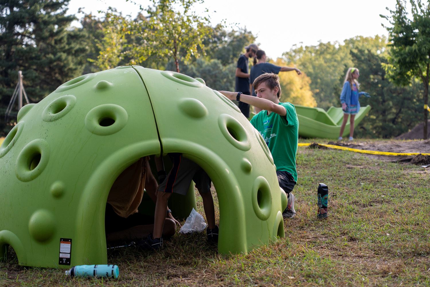 Neighborhood volunteers help build the new playground at Keya Park.