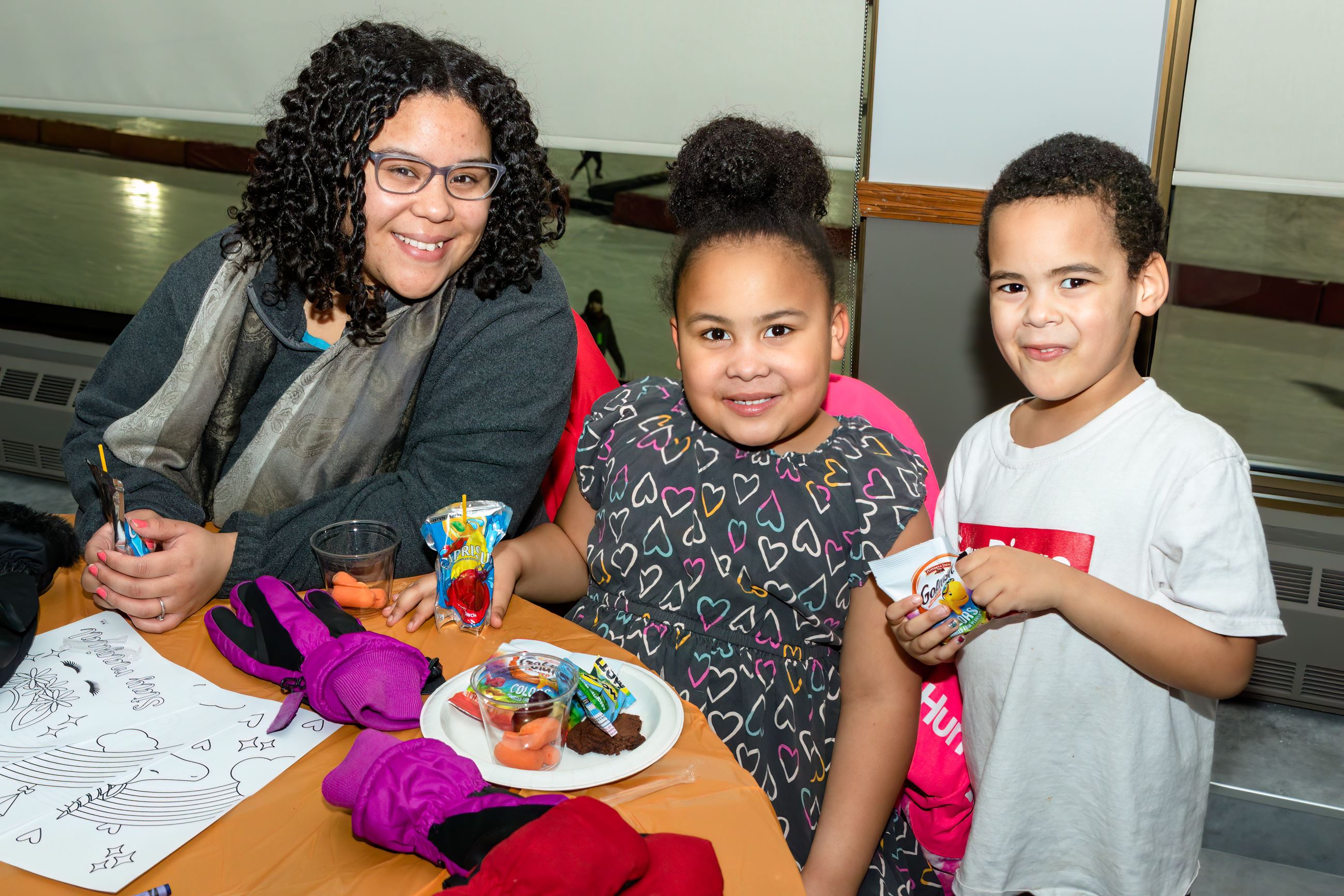 A family sitting at a table eating treats