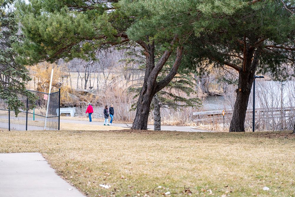 People walk around Bennett Lake at Roseville's Central Park on a March afternoon.