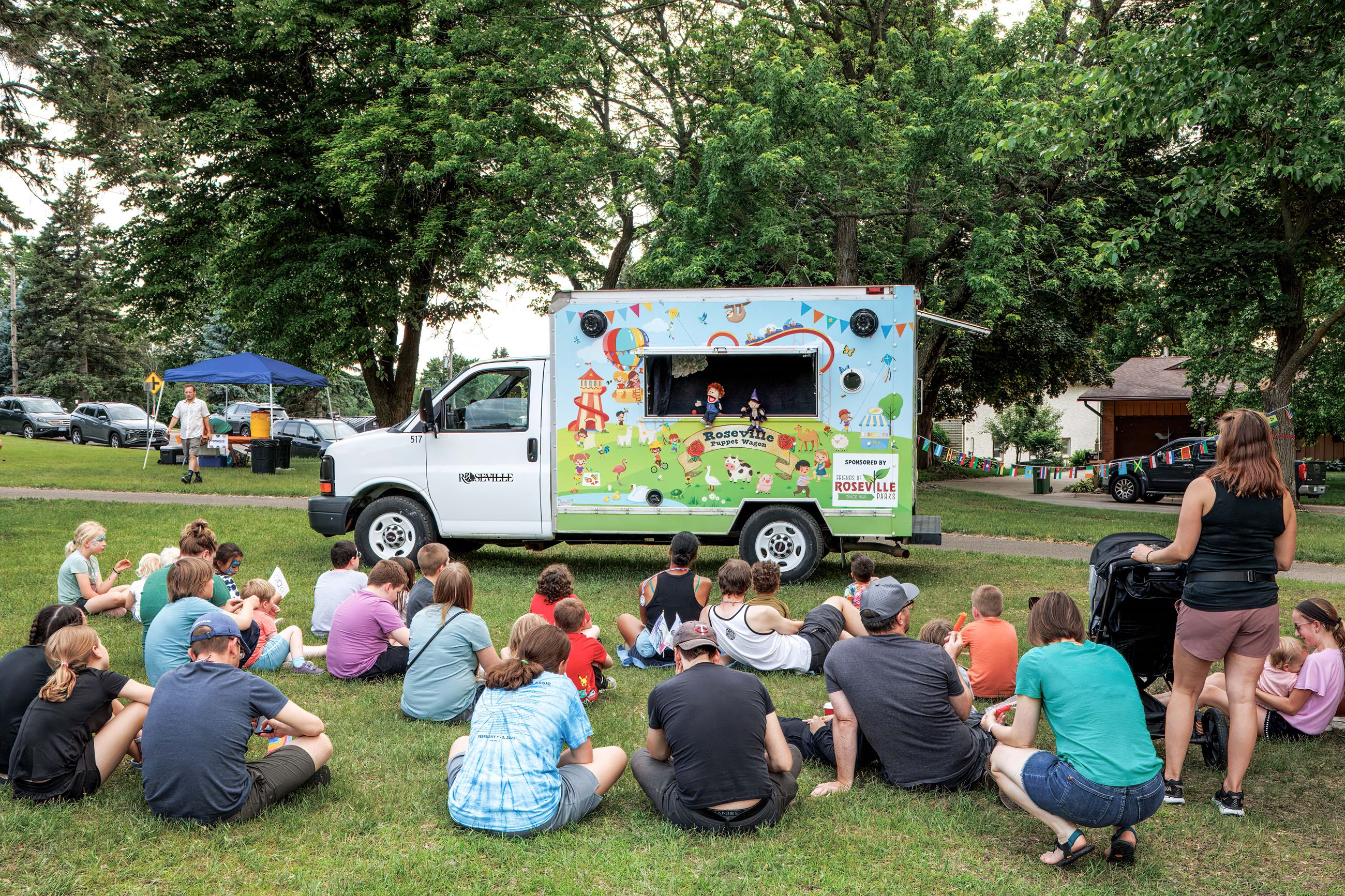 The puppet wagon performing in front of a group of people